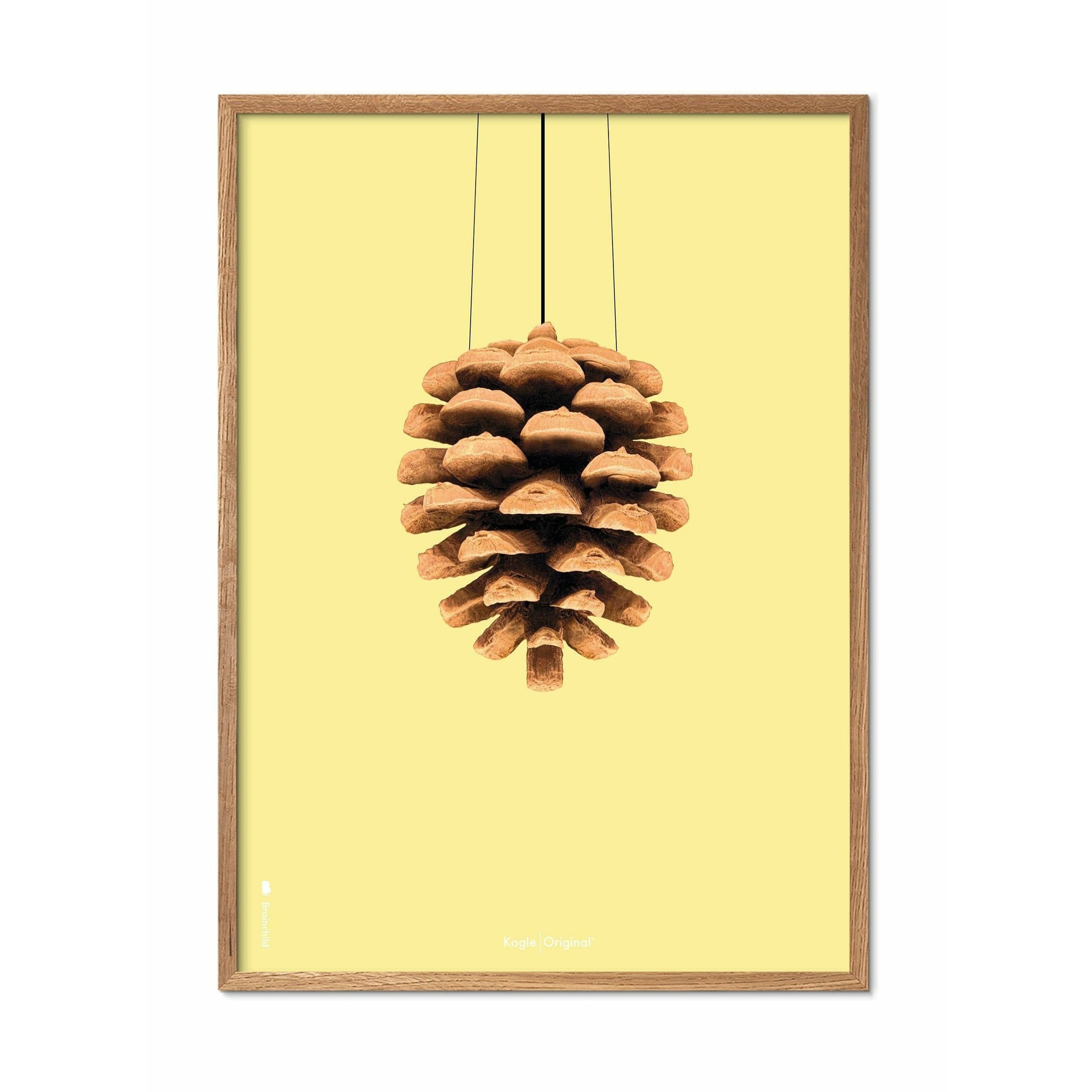 Brainchild Pine Cone Classic Poster, frame gemaakt van licht hout 50x70 cm, gele achtergrond